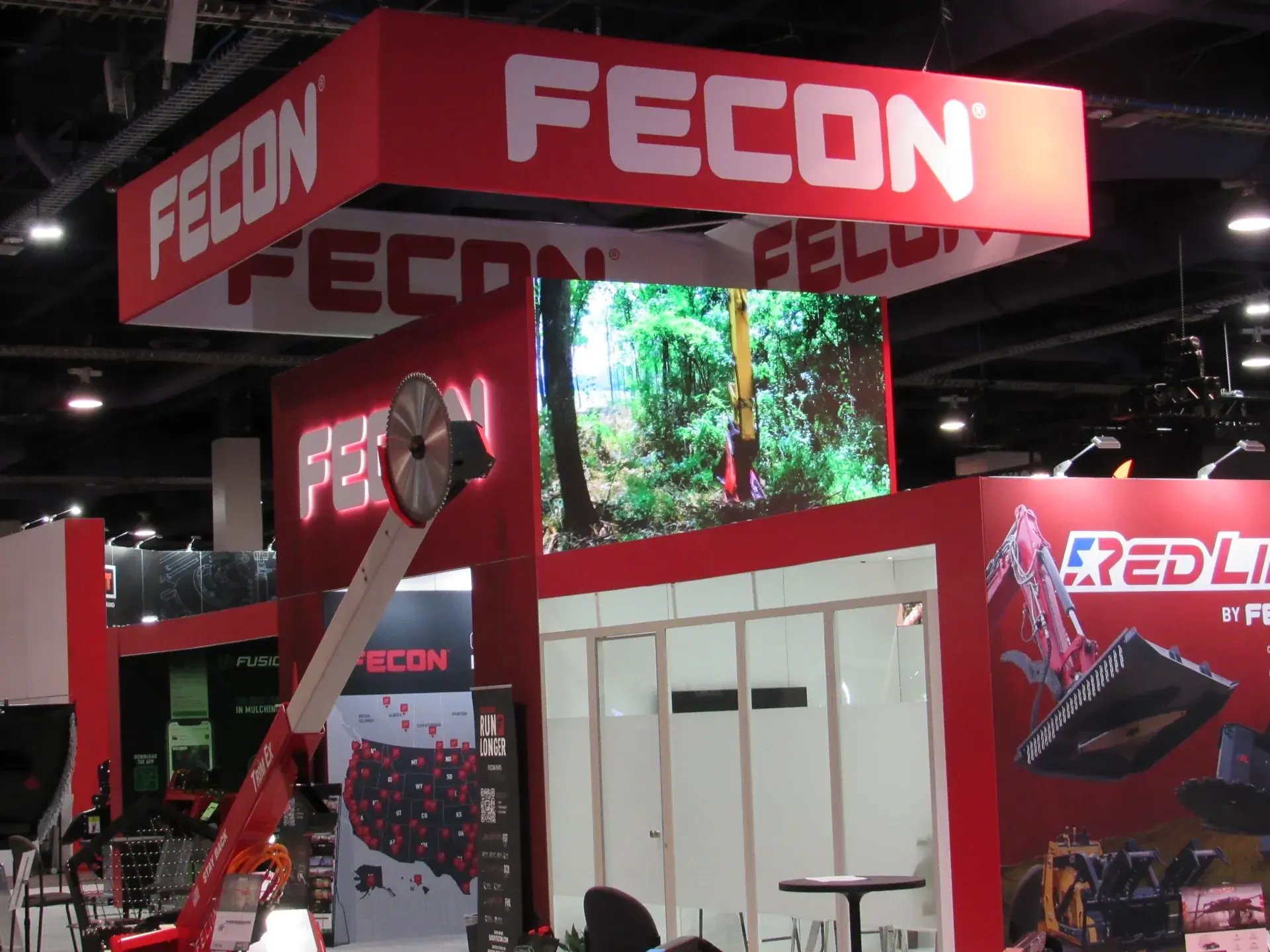 Bold illuminated FECON logo on a red brand wall