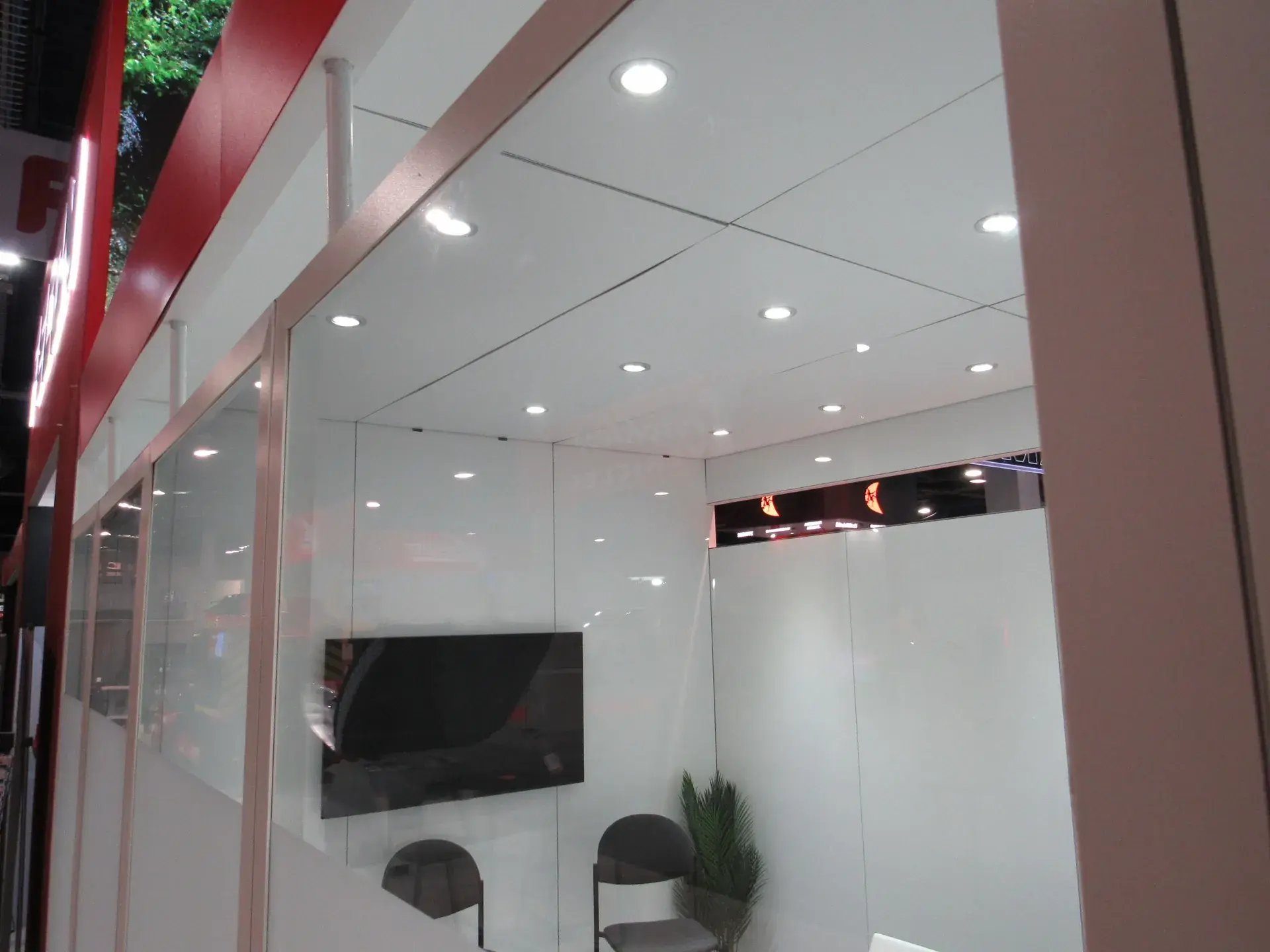 Enclosed private conference room with acrylic glass walls inside the Fecon exhibit