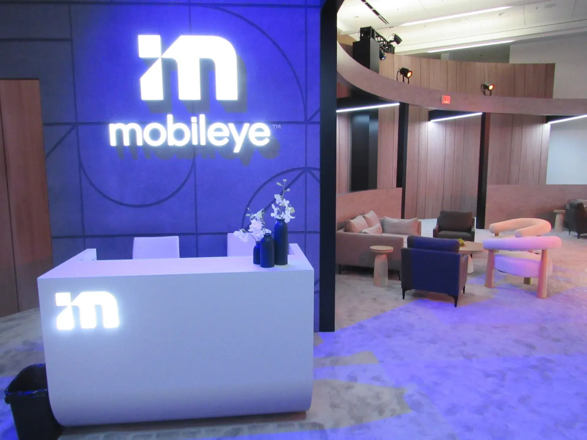 Branded reception area with illuminated logo wall and custom welcome counter
