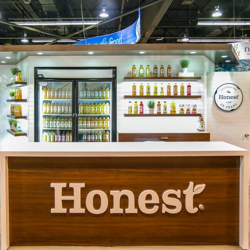 honest tea trade show booth with backlit products highlighting their teas and juices