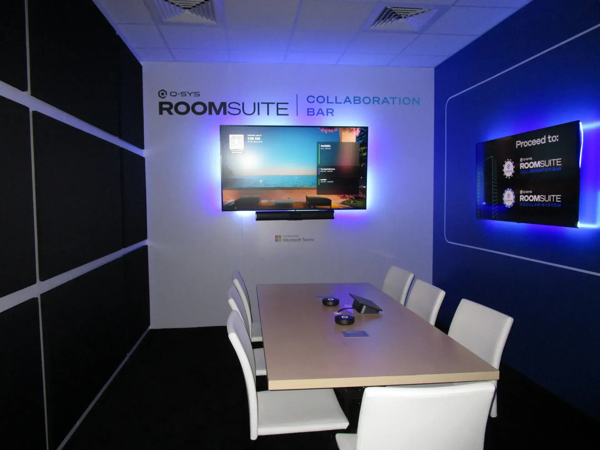RoomSuite Collaboration Bar meeting room with blue architectural accent walls and integrated displays