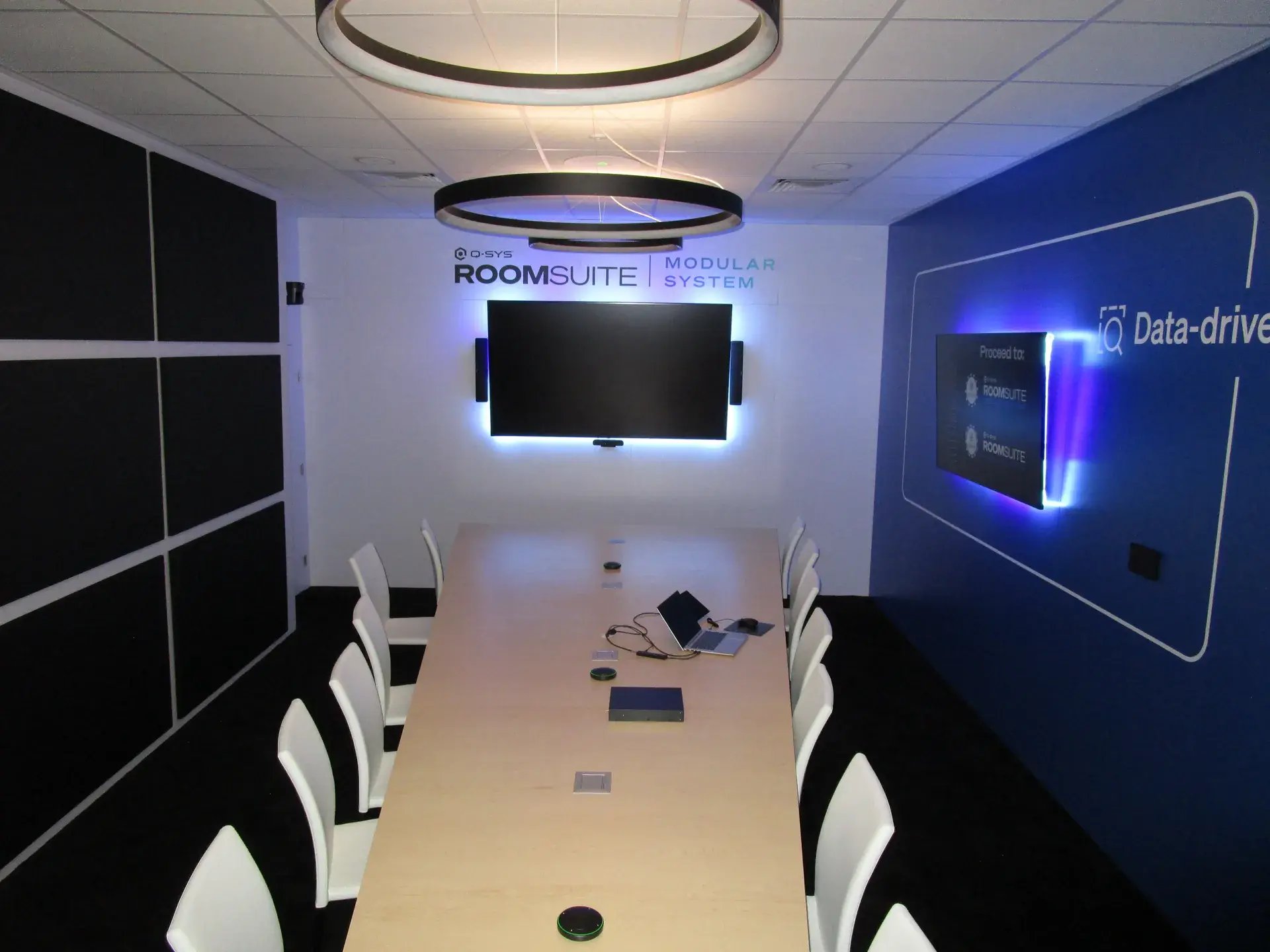 RoomSuite Modular conference environment with tapered conference table, acoustic treatments and ring lighting
