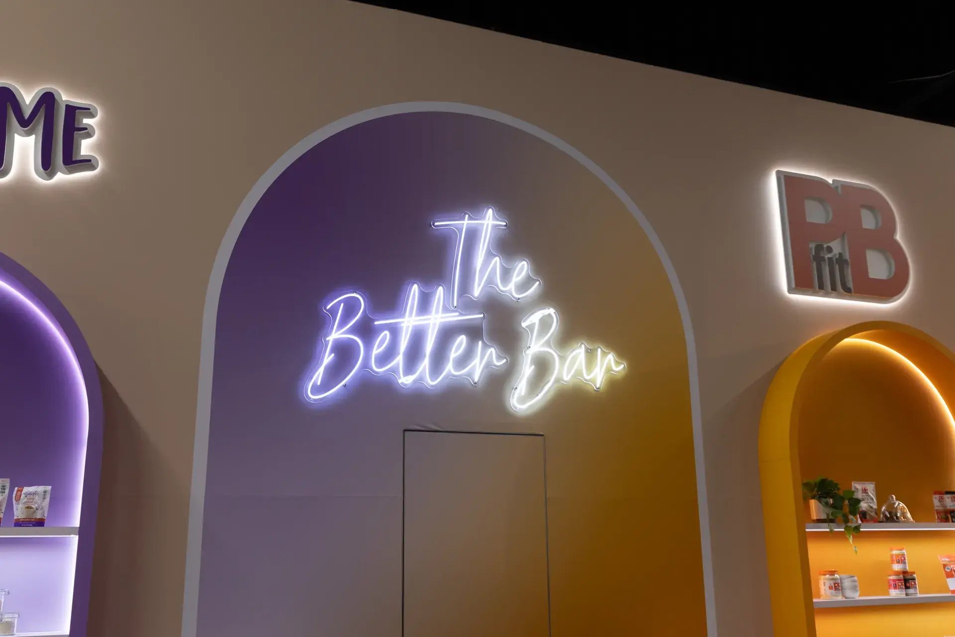 Custom illuminated The Better Bar neon feature beside the PBfit logo