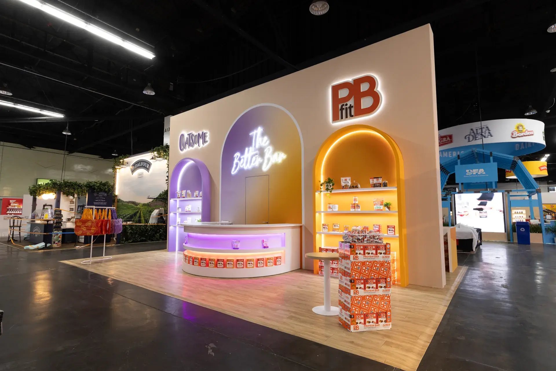 Angled view of the BetterBody Foods exhibit showing the PBfit and Oatsome brand zones