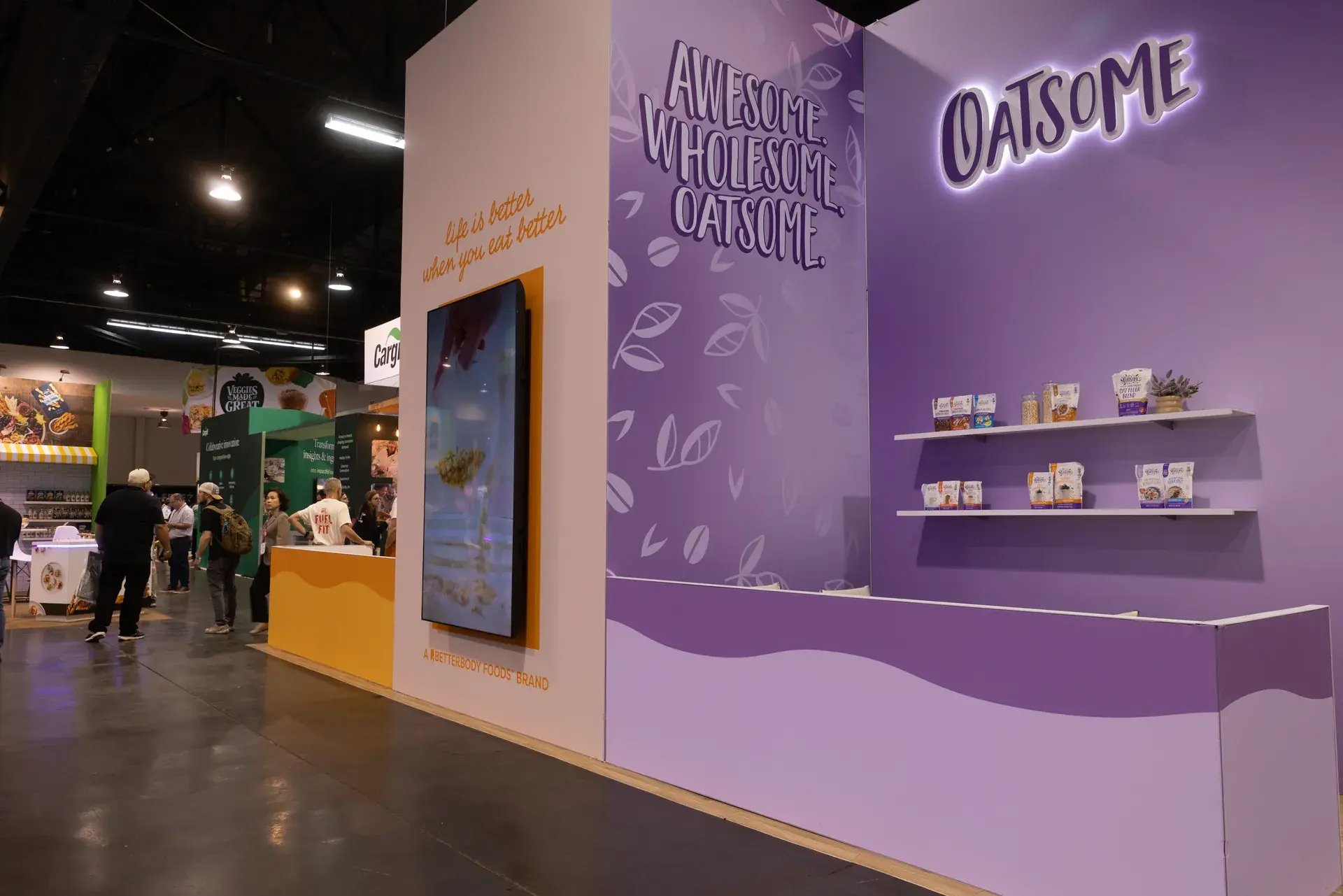 Oatsome brand wall with a large-format 98-inch digital display and product shelving