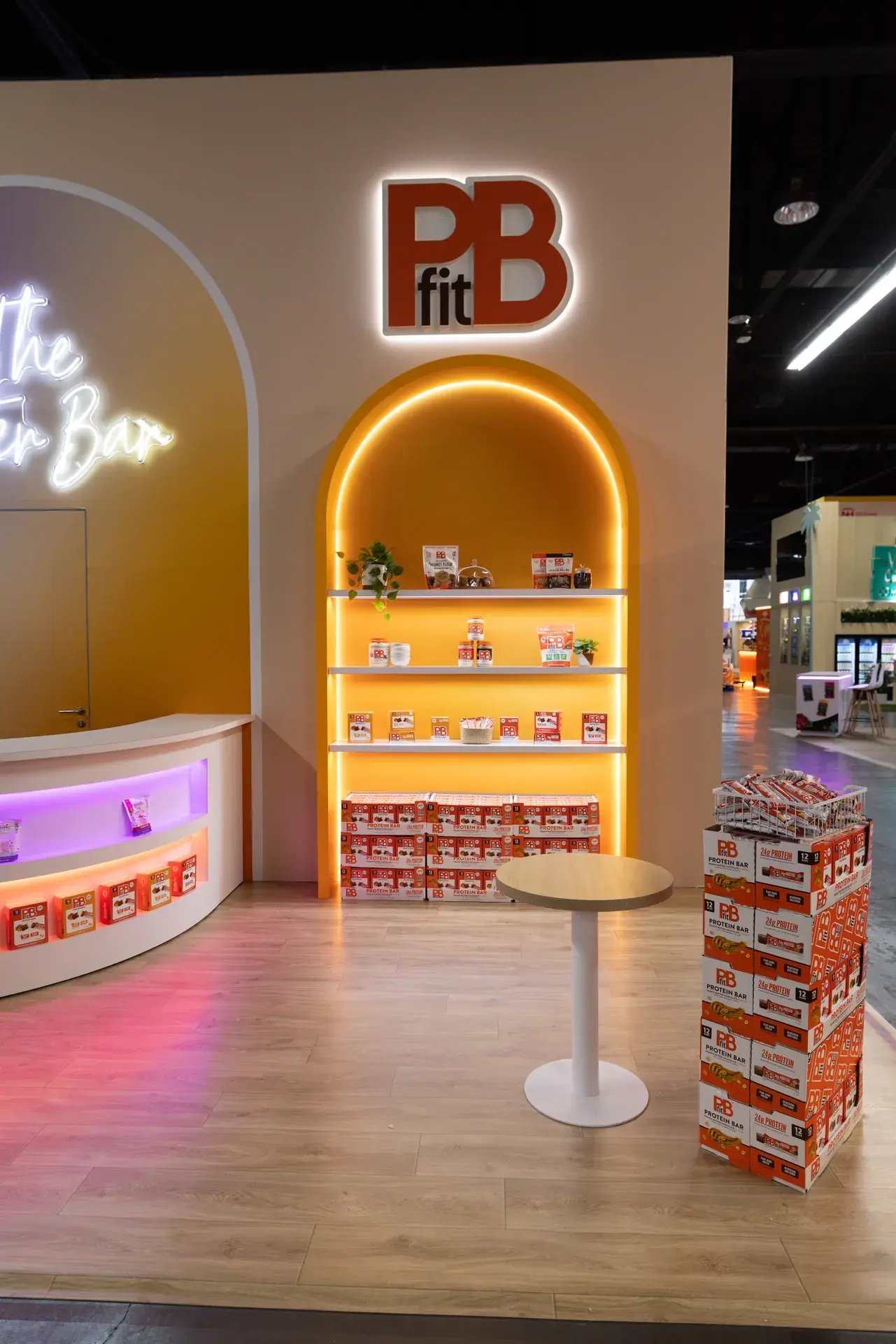 Illuminated PBfit product alcove with orange shelving